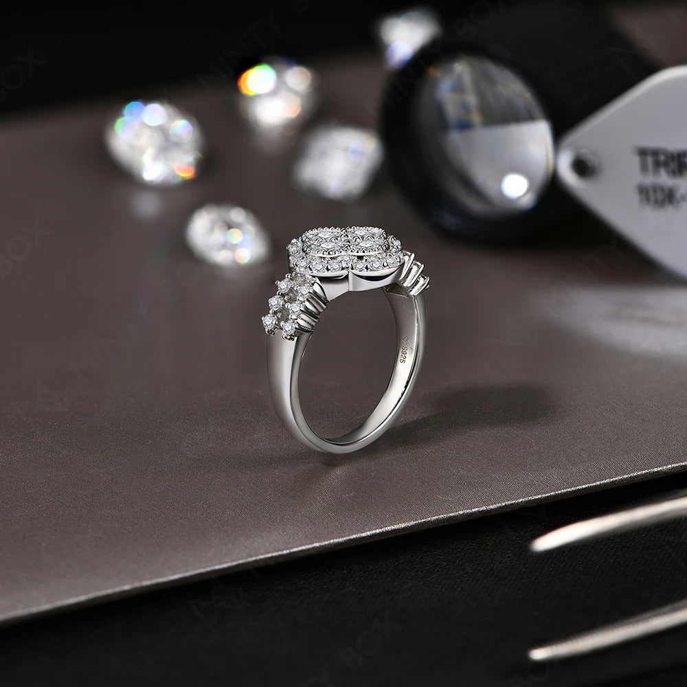 Elegant four-leaf ring symbolizing love and luck, crafted in sterling silver with sparkling moissanite stone.